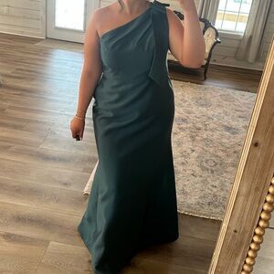 Bow one-shoulder satin twill trumpet gown. Dessy Group in shade evergreen.